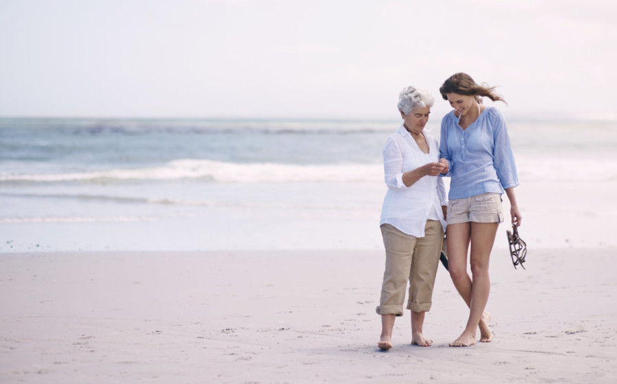Mother-Daughter-Walking-On-Beach