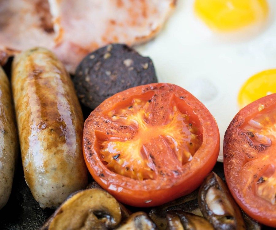 Full English Breakfast as a Hangover Cure with eggs, bacon, sausages, tomato and mushrooms