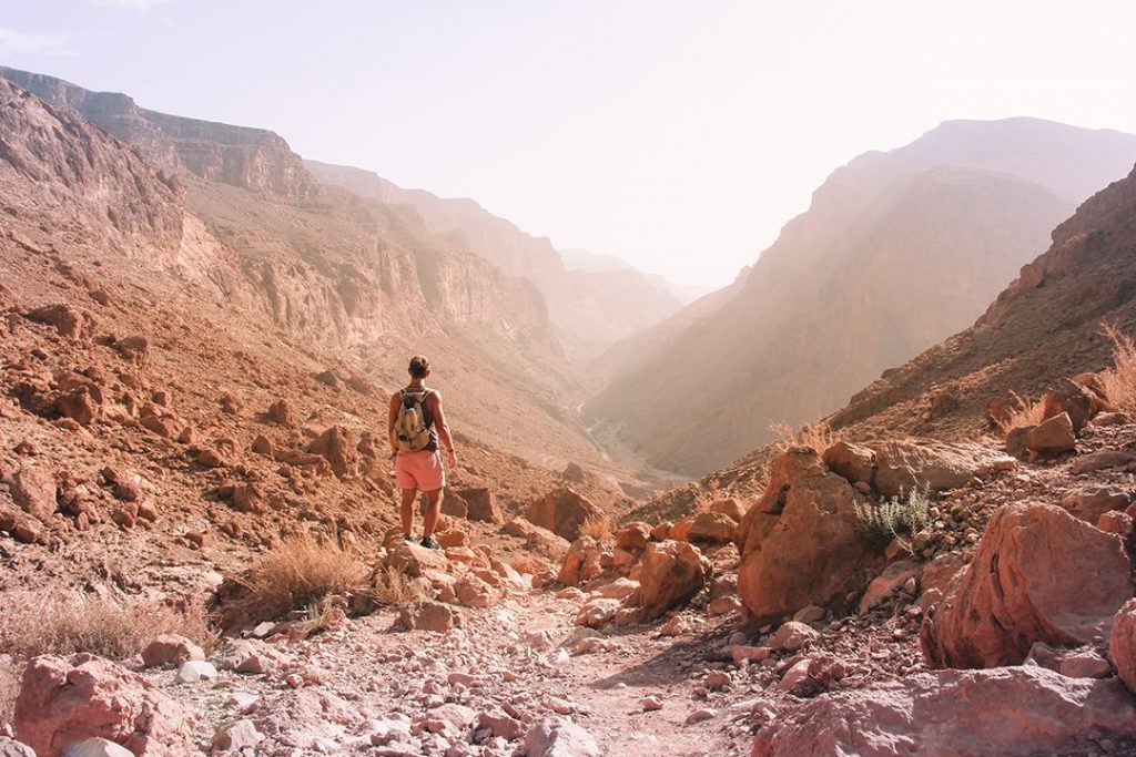 A hiker stops to look at the expansive landscape of Todgha Gorge