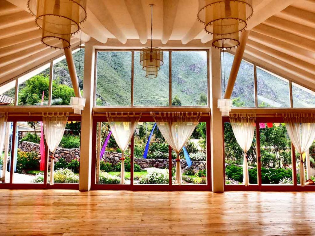 A wooden yoga studio in Peru looking out to the rolling hills 