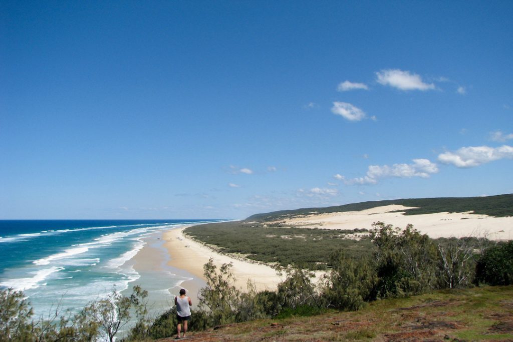 The speck of a man can be seen talking a picture of 75 Mile Beach, Fraser Island, Queensland