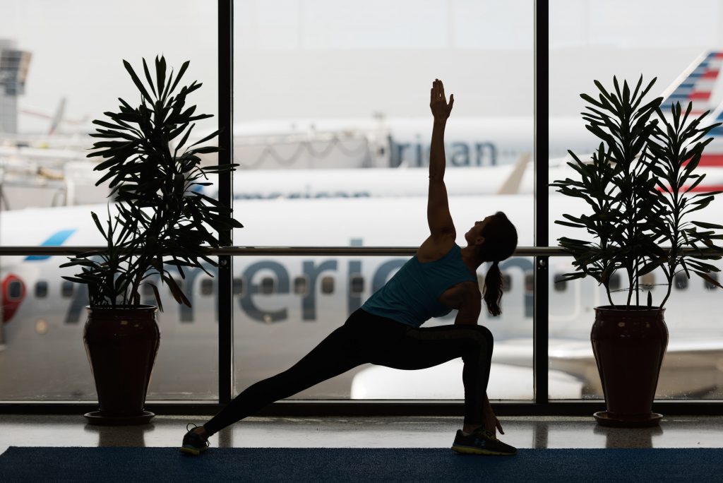 A woman relaxes into a yoga pose at Dallas/Fort Worth International Airport