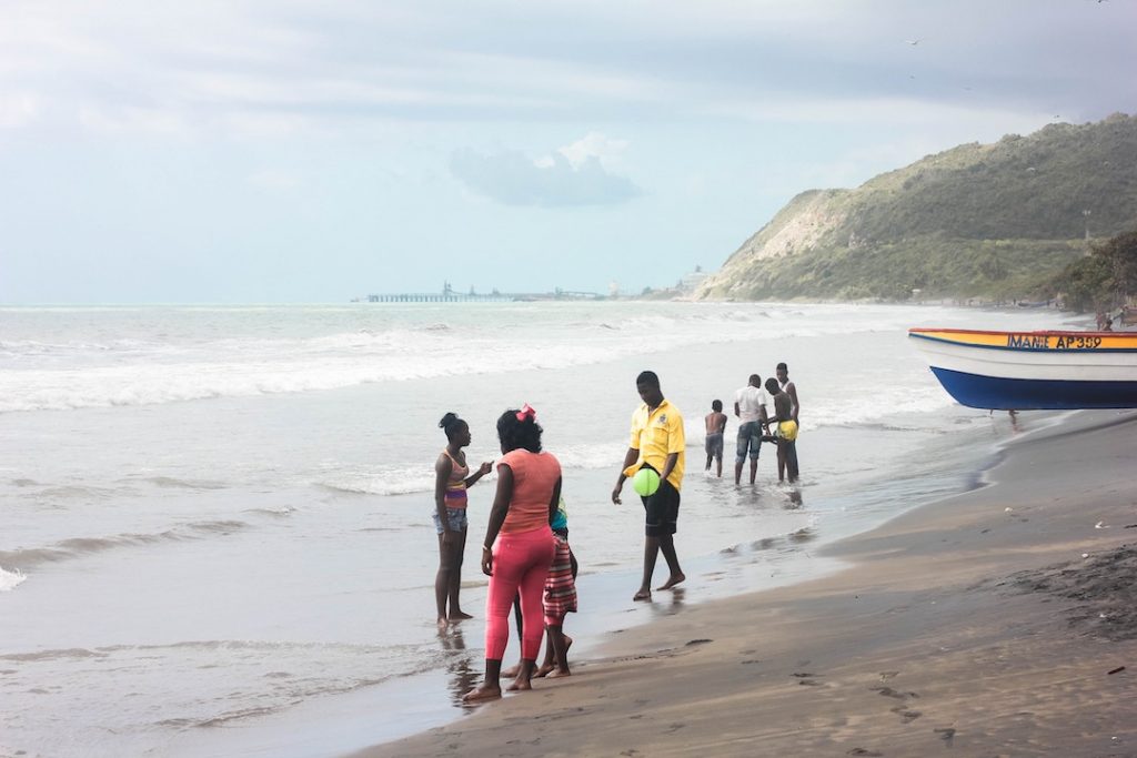 Locals gathering on a beach in Kingston, Jamaica