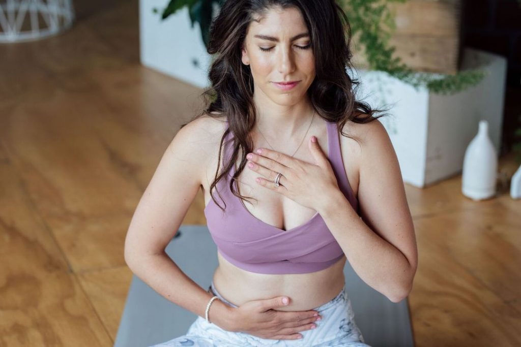 Davida Lederle of The Healthy Maven practices her breath work on the mat