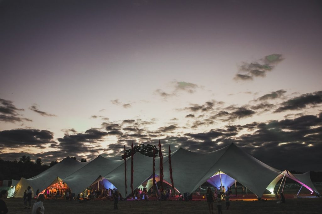 a series of tents lit in green and blue