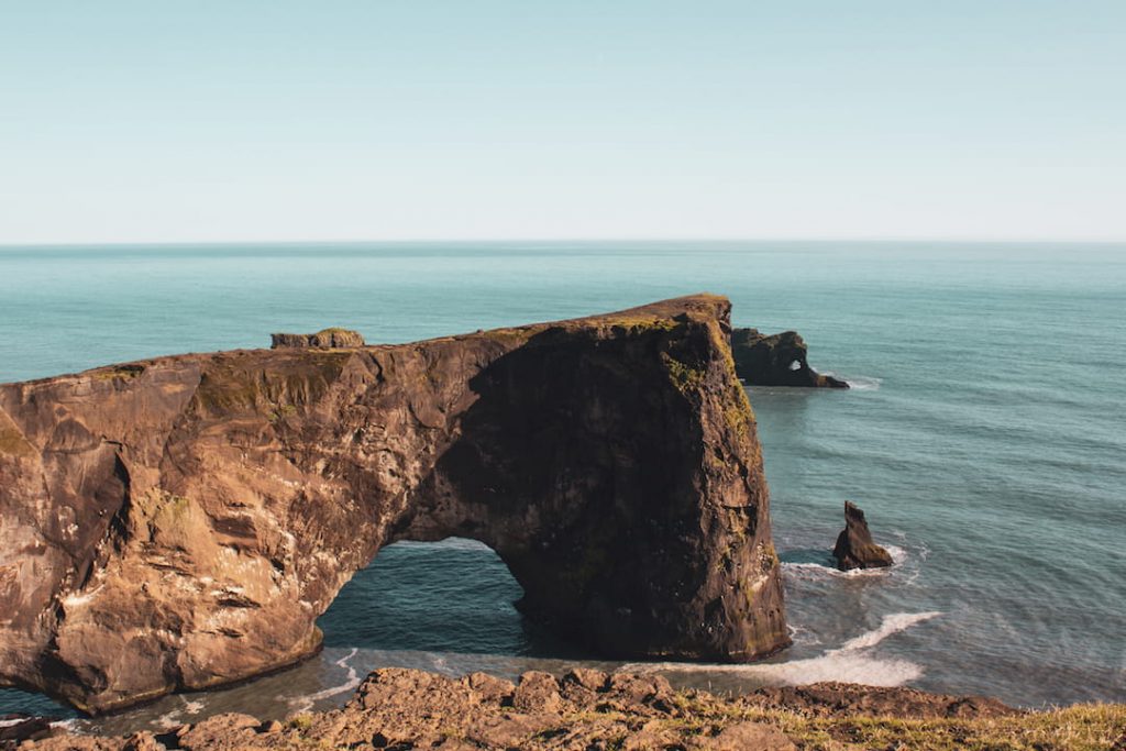 A cliff and rock faces on a beach in Southern Iceland