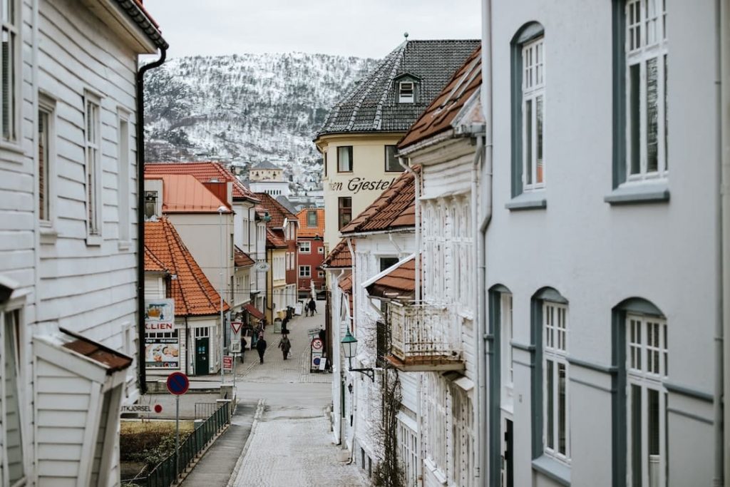 A narrow street with a mountain in the background in Norway
