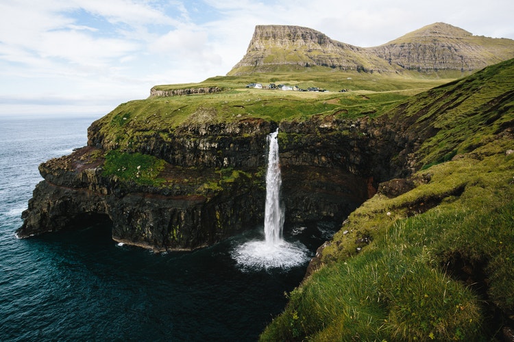 A waterfall gushes into the sea in Gasadalur, Faroe Islands