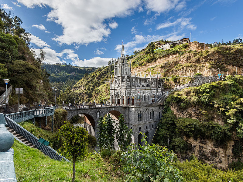 Sanctuary of Las Lajas, Ipiales, Colombia - a Gothic church with a bridge leading up to it is surrounded by rolling green hills