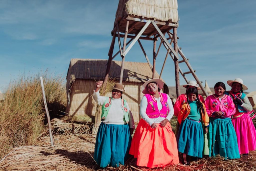 A row of women in colourful traditional outfits, Lake Titicaca