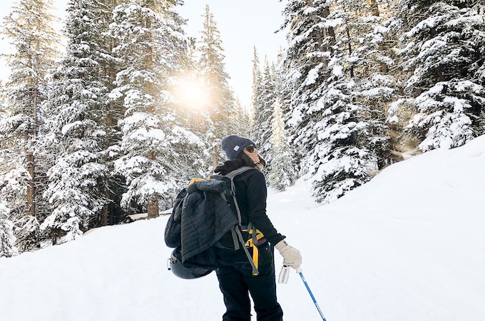 A woman cross-country skiing on the Mayflower Gulch Trail, Frisco, US