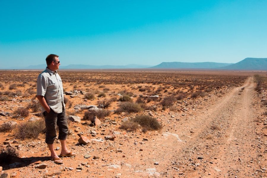 A man standing in Africa looking out into the distance 