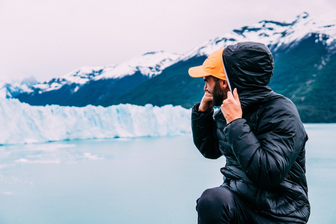 man looking at glacier