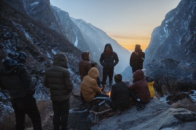 A group of people on the Annapurna Circuit standing around a fire