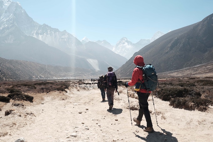 People hiking with poles in Nepal