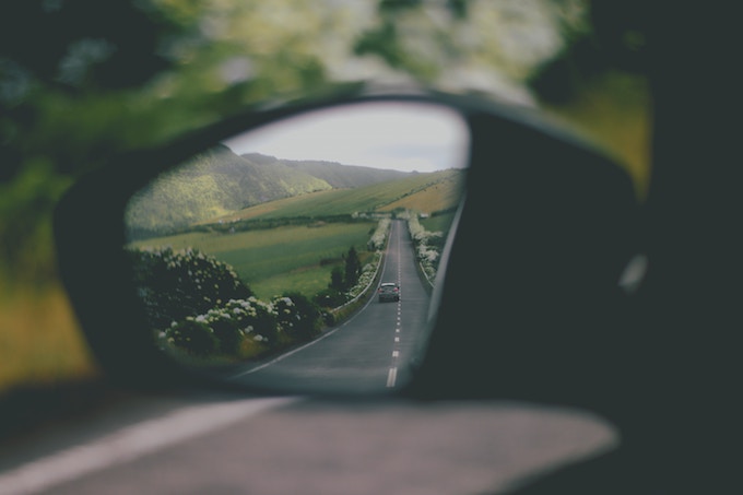 A car mirror showing a road in Ponta Delgada, Portugal