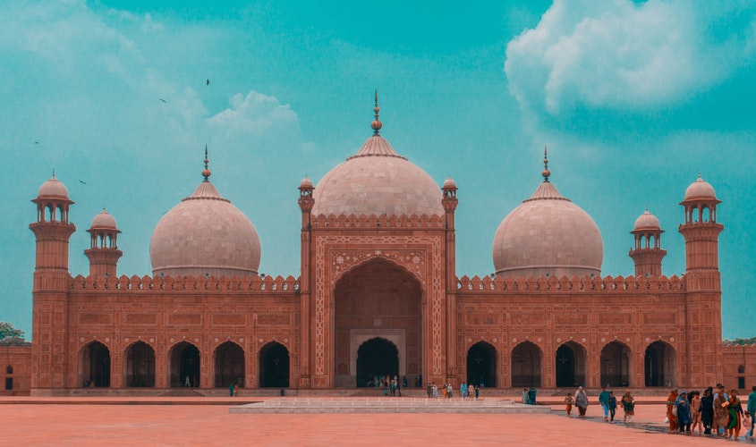 Badshahi Mosque, Lahore: people in front of the sandy coloured dome building