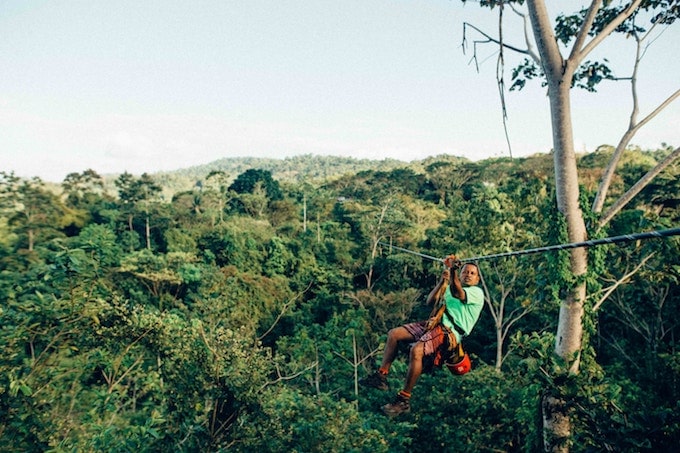 A man ziplining in costa rica