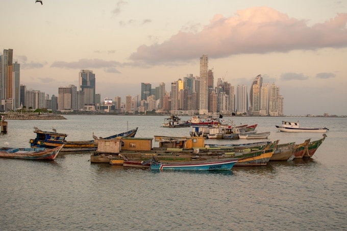 Boats in the ocean against the panama city skyline