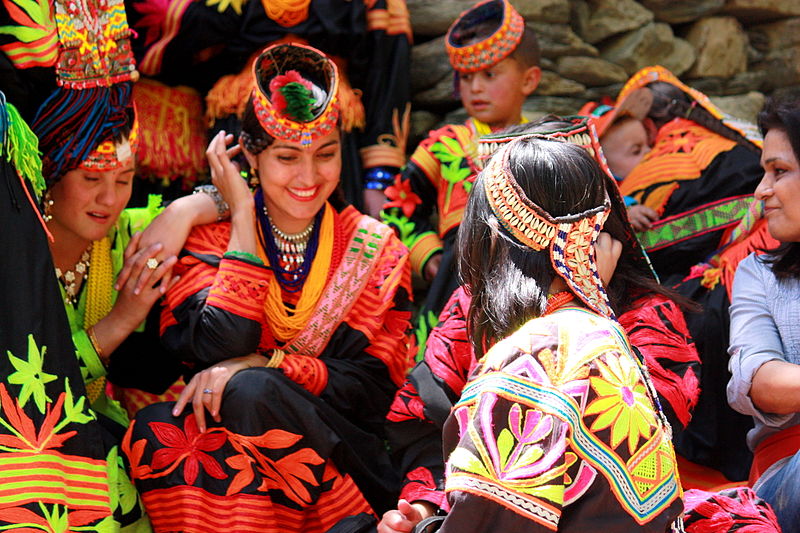 a group of kalash women in colourful clothing smiling