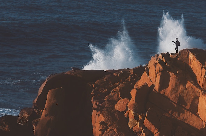 A man on a cliff in Asilah, Morocco