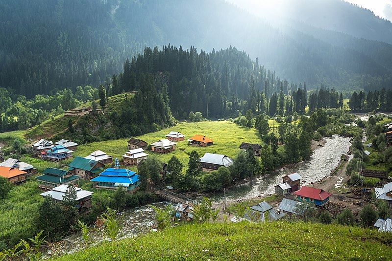 neelum valley: aerial view of a small village with colouful houses in a green valley