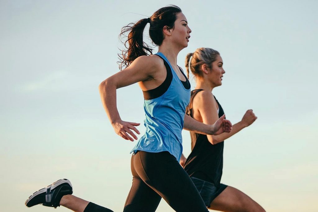 two women running side by side