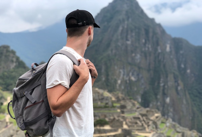 A man looking down onto Machu Picchu, Peru