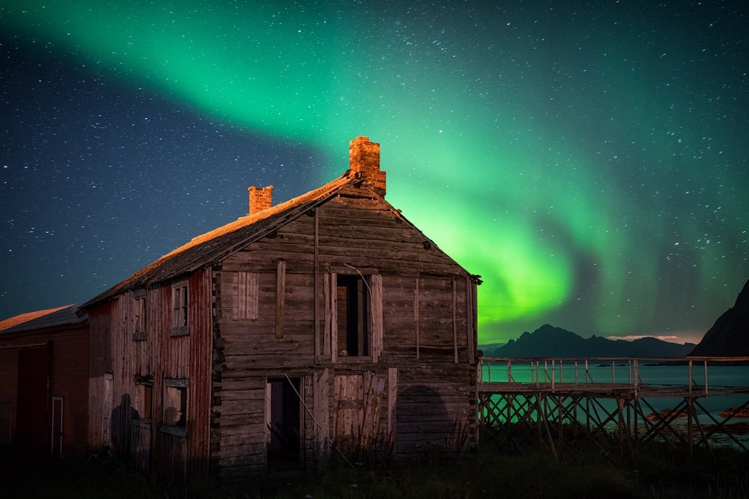 The northern lights over an abandoned barn in Hovden, Norway