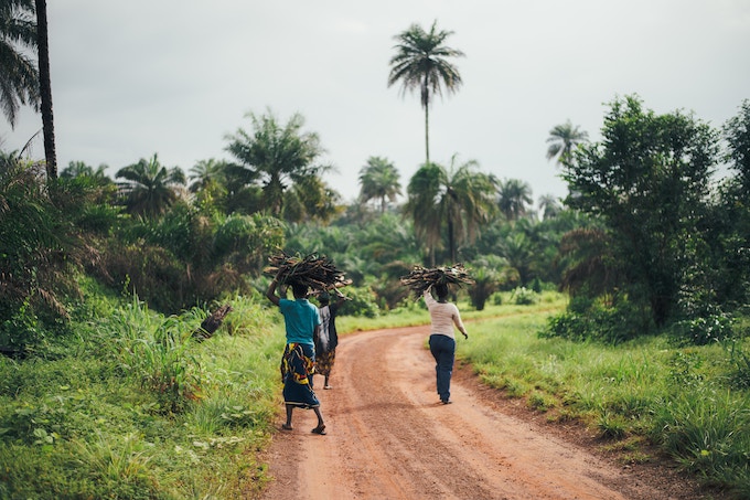 People walking down a dirt road in Sierra Leone