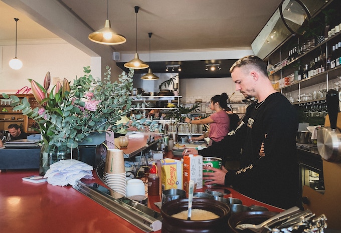 A man behind the counter at a restaurant in Australia