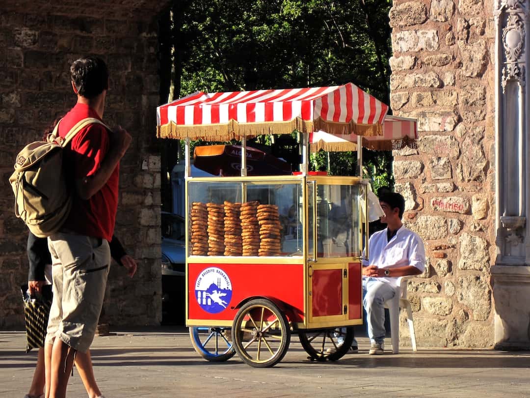 Vendor selling simit from a red push-cart in Istanbul, Turkey