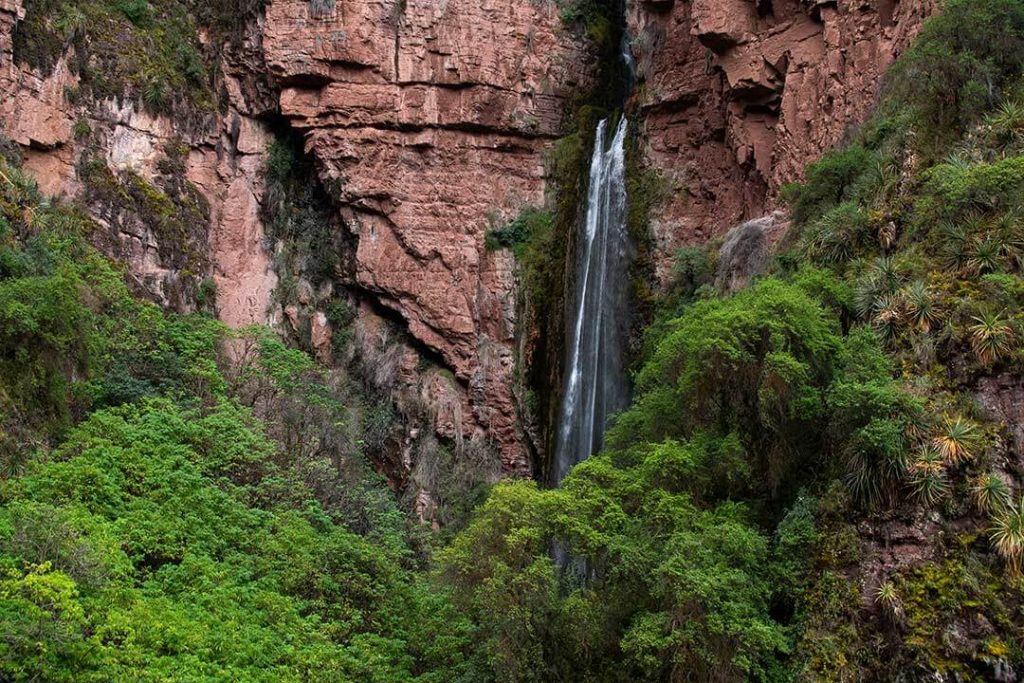 a waterfall coming out of the side of a cliff