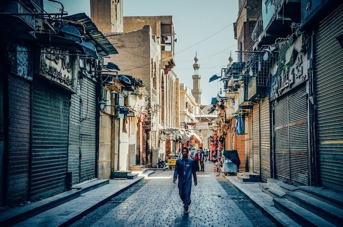 A man walking through a market in Cairo, Egypt