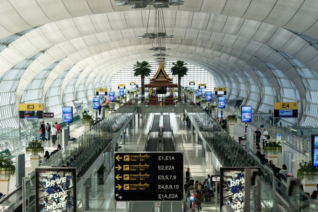 shot of an airport with escalators and signs