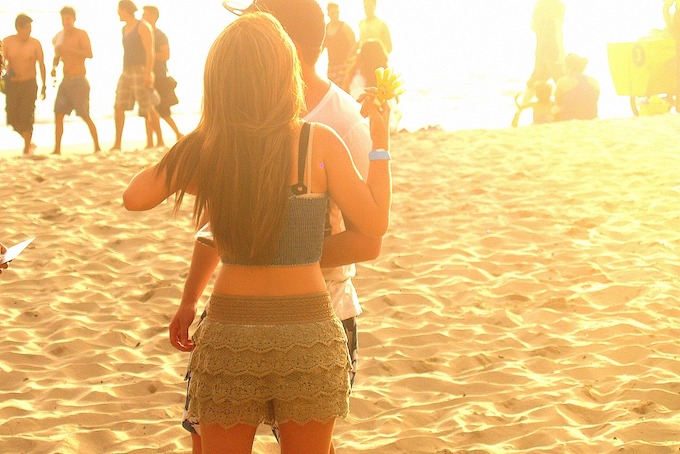 A male/female couple embracing at sunset in Montanita, Ecuador