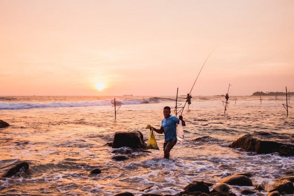 Locals fishing at sunset at Unawatuna Beach, Sri Lanka