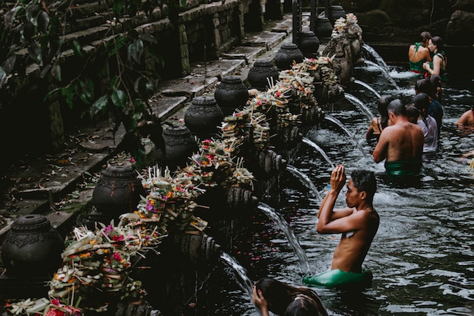 Boys bathing in a fountain in Bali