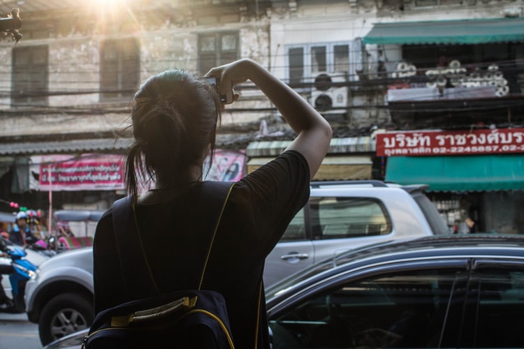 a woman taking pictures of some buildings
