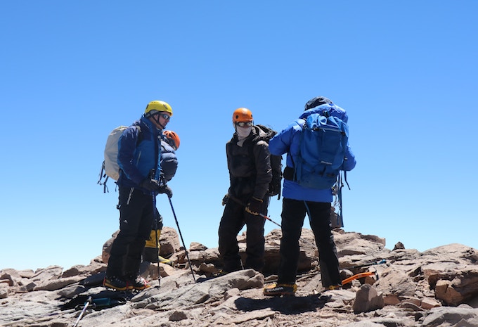 Three people in climbing gear on Mount Kilimanjaro