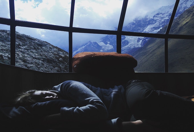 A woman sleeping in a glass igloo in Peru