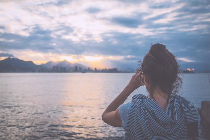 A girl looking at the Rio skyline from the sea