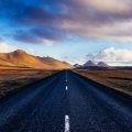 black concrete road with distance to mountains