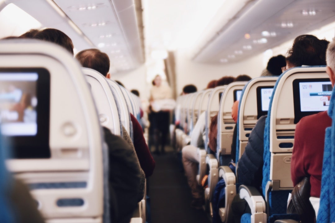 Flight attendant walking down the aisle on a flight