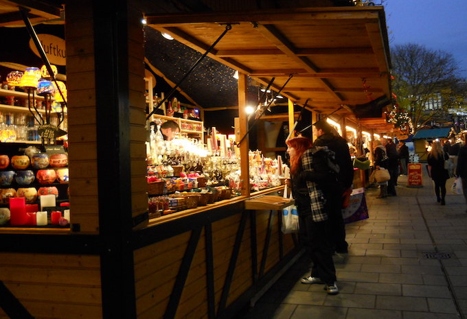 A woman standing at a Christmas market stall in Bristol