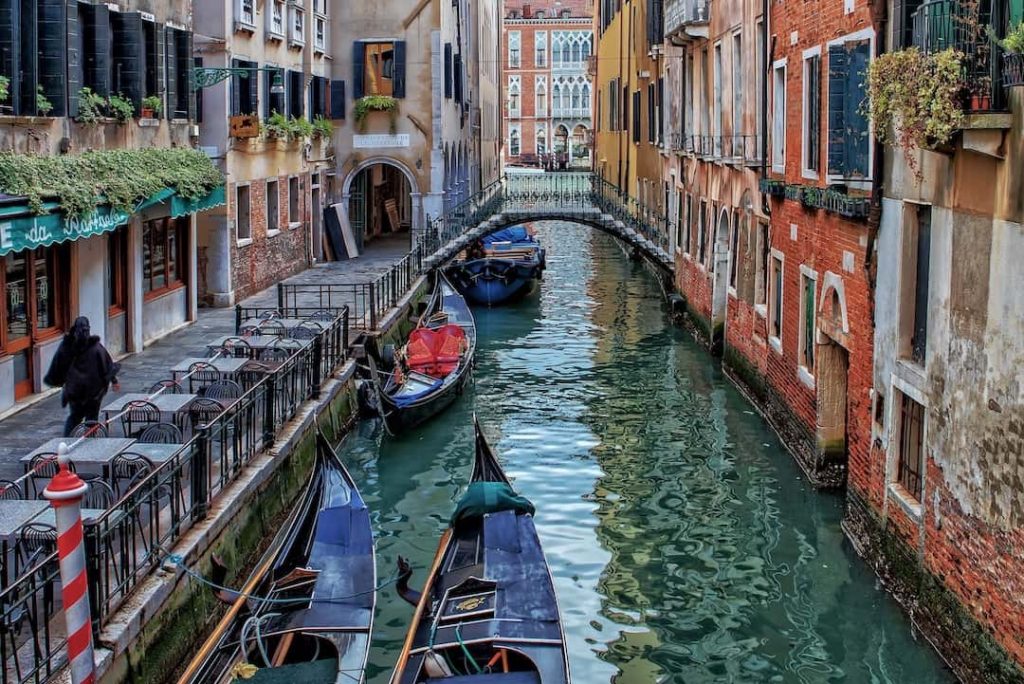Gondolas docked along a canal in Venice, Italy