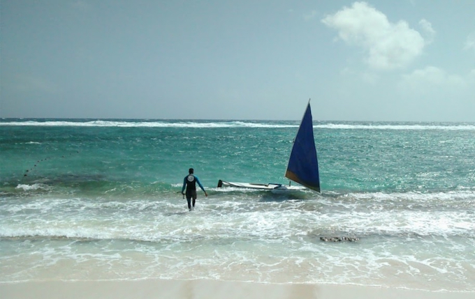 a man walking into the surf