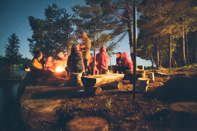 Friends around a campfire in Muskoka, Canada