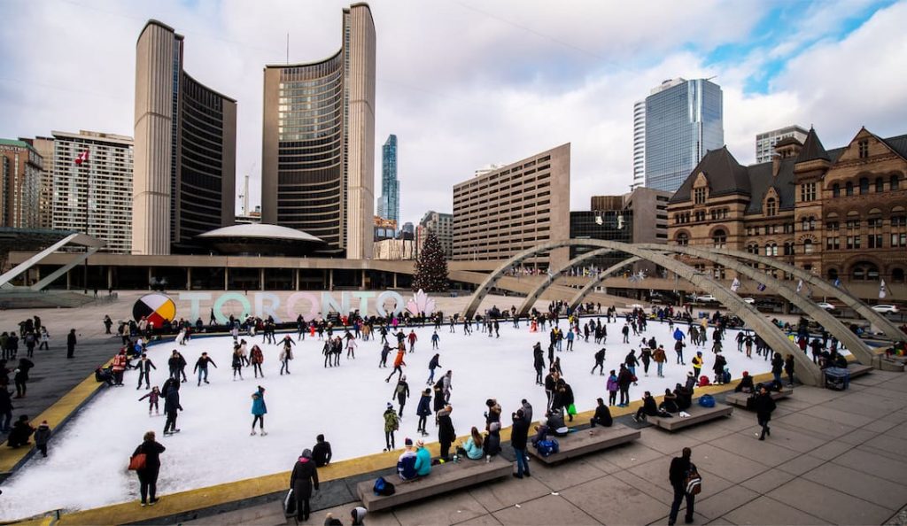 People skating at Nathan Phillips Square in Toronto, Canada