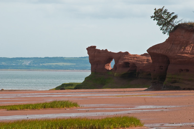 a red ocean bed by the sea with red odd shaped boulders along the coast